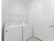 Functional laundry room with washer and dryer at 9982 Beachwalk Dr, Englewood, FL 34223