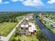 Aerial view of condo community near canal with pool and parking at 66 Boundary Blvd # 238, Rotonda West, FL 33947