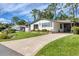 Single-wide manufactured home with carport and landscaping at 816 Manchester Ct, Englewood, FL 34223