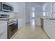 Kitchen boasts stainless steel appliances and white cabinets at 1502 Hazelton Ave, North Port, FL 34286