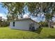 Side view of house showcasing exterior finishes and landscaping at 1502 Hazelton Ave, North Port, FL 34286