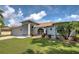 Single story home with gray exterior, brown roof, and nicely landscaped lawn at 1502 Hazelton Ave, North Port, FL 34286