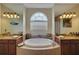 Elegant bathroom with double sinks, a large soaking tub, and a separate shower at 229 Rotonda E Blvd, Rotonda West, FL 33947