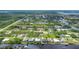 Wide aerial view of a waterfront community with many houses at 15595 Staunton Cir, Port Charlotte, FL 33981