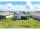 Home's exterior showcasing backyard and screened patio at 14589 Ponce De Leon Trl, Port Charlotte, FL 33981