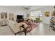Spacious living room with light tile flooring, comfortable seating, and large sliding glass doors at 14589 Ponce De Leon Trl, Port Charlotte, FL 33981