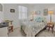 Cozy bedroom featuring a full-size bed, window, and tasteful decor at 14589 Ponce De Leon Trl, Port Charlotte, FL 33981