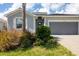 New home with gray siding, tile roof, and two-car garage, located in a residential community at 14589 Ponce De Leon Trl, Port Charlotte, FL 33981