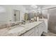 Double vanity bathroom with granite countertop, large mirror, and a walk-in shower at 14589 Ponce De Leon Trl, Port Charlotte, FL 33981