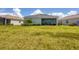 Spacious backyard with grassy lawn and view of home's exterior at 14589 Ponce De Leon Trl, Port Charlotte, FL 33981