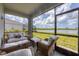 Enjoy water views from this comfortable screened patio furnished with wicker seating at 14589 Ponce De Leon Trl, Port Charlotte, FL 33981