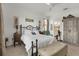 Spacious bedroom with a queen bed, ensuite bathroom access, and an antique wardrobe at 14589 Ponce De Leon Trl, Port Charlotte, FL 33981