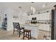 Modern kitchen with white cabinets, granite countertops, and island at 14589 Ponce De Leon Trl, Port Charlotte, FL 33981