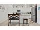 Kitchen features white cabinets, granite countertops, and breakfast bar at 14589 Ponce De Leon Trl, Port Charlotte, FL 33981