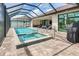 Enjoy this refreshing pool and spa with covered patio at 15320 Hennipen Cir, Port Charlotte, FL 33981