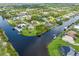 Bird's-eye view of waterfront home and surrounding neighborhood at 15320 Hennipen Cir, Port Charlotte, FL 33981