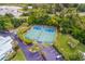 Aerial view of tennis courts, parking lot, landscaping, and buildings at 11000 Placida Rd # 2303, Placida, FL 33946