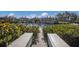 View of dock with water access, landscaping, and buildings at 11000 Placida Rd # 2303, Placida, FL 33946