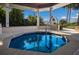 This outdoor hot tub has a blue tile finish and is adjacent to palm trees and a relaxing fenced-in patio at 11000 Placida Rd # 2303, Placida, FL 33946