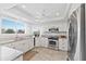 Bright kitchen featuring granite counters, stainless appliances, white cabinetry, and tile flooring at 11000 Placida Rd # 2303, Placida, FL 33946