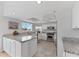 Well-lit kitchen featuring granite countertops, stainless steel appliances, and ample white cabinetry at 11000 Placida Rd # 2303, Placida, FL 33946