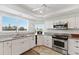 Bright kitchen with white cabinets, stainless steel appliances, and granite countertops, bathed in natural light at 11000 Placida Rd # 2303, Placida, FL 33946