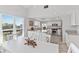 Open-concept kitchen and dining area with white cabinetry, stainless appliances and lots of natural light at 11000 Placida Rd # 2303, Placida, FL 33946