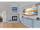 Cozy living room featuring a fireplace, beach-themed artwork, and a large TV at 11000 Placida Rd # 2303, Placida, FL 33946