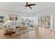 Spacious living room with hardwood floors, large windows, a comfortable sectional sofa and a ceiling fan at 11000 Placida Rd # 2303, Placida, FL 33946