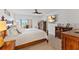 Comfortable main bedroom with a balcony, TV, and wooden furniture at 11000 Placida Rd # 2303, Placida, FL 33946