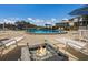 Community pool and lounging area featuring a fire pit with patio furniture at 11000 Placida Rd # 2303, Placida, FL 33946