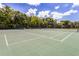 View of community tennis courts, surrounded by lush landscaping at 11000 Placida Rd # 2303, Placida, FL 33946