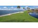 Waterfront lawn with park benches and water views at 11000 Placida Rd # 2303, Placida, FL 33946