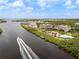 Aerial view of community including waterfront condos, pools, boat and lush landscaping at 11160 Hacienda Del Mar Blvd # D-205, Placida, FL 33946