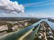 Stunning aerial view of coastal condos surrounded by waterways and lush landscape under a blue, partly cloudy sky at 11160 Hacienda Del Mar Blvd # D-205, Placida, FL 33946