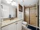 Well-lit bathroom featuring a shower with glass door and vanity with granite countertop at 11160 Hacienda Del Mar Blvd # D-205, Placida, FL 33946