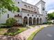 Elegant condo entrance with covered portico, decorative columns and manicured landscaping at 11160 Hacienda Del Mar Blvd # D-205, Placida, FL 33946