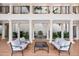 Courtyard with cushioned chairs and couches around a small glass table and a central water feature at 11160 Hacienda Del Mar Blvd # D-205, Placida, FL 33946