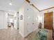 Welcoming condo foyer featuring neutral tile flooring, wooden trim, and a decorative area rug at 11160 Hacienda Del Mar Blvd # D-205, Placida, FL 33946