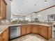 Open kitchen with granite countertops, light wood cabinetry, and stainless steel appliances at 11160 Hacienda Del Mar Blvd # D-205, Placida, FL 33946