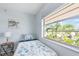 Bedroom with twin bed, ocean view, and ceiling fan at 2375 N Beach Rd # 3B, Englewood, FL 34223
