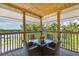 Relaxing covered deck with outdoor furniture and scenic water views at 2375 N Beach Rd # 3B, Englewood, FL 34223