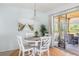 Charming dining area with table and chairs near sliding glass doors at 2375 N Beach Rd # 3B, Englewood, FL 34223