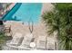 Inviting pool with lounge chairs and patio area at 2375 N Beach Rd # 3B, Englewood, FL 34223