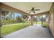 Screened porch with ceiling fan and view of yard at 3288 Myrica St, North Port, FL 34286