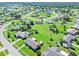 Aerial view showcasing the neighborhood with verdant lawns and tree-lined streets at 6367 Facet Ln, Port Charlotte, FL 33981