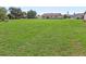 Expansive backyard with lush green lawn extending from the house at 6367 Facet Ln, Port Charlotte, FL 33981