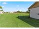 Spacious backyard with verdant lawn and ample space for outdoor activities at 6367 Facet Ln, Port Charlotte, FL 33981