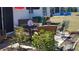 Patio area featuring a table with chairs, lounge seating, and surrounding shrubs at 6367 Facet Ln, Port Charlotte, FL 33981