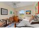 Bright bedroom featuring a window, dresser, chess table, and comfortable seating at 6367 Facet Ln, Port Charlotte, FL 33981